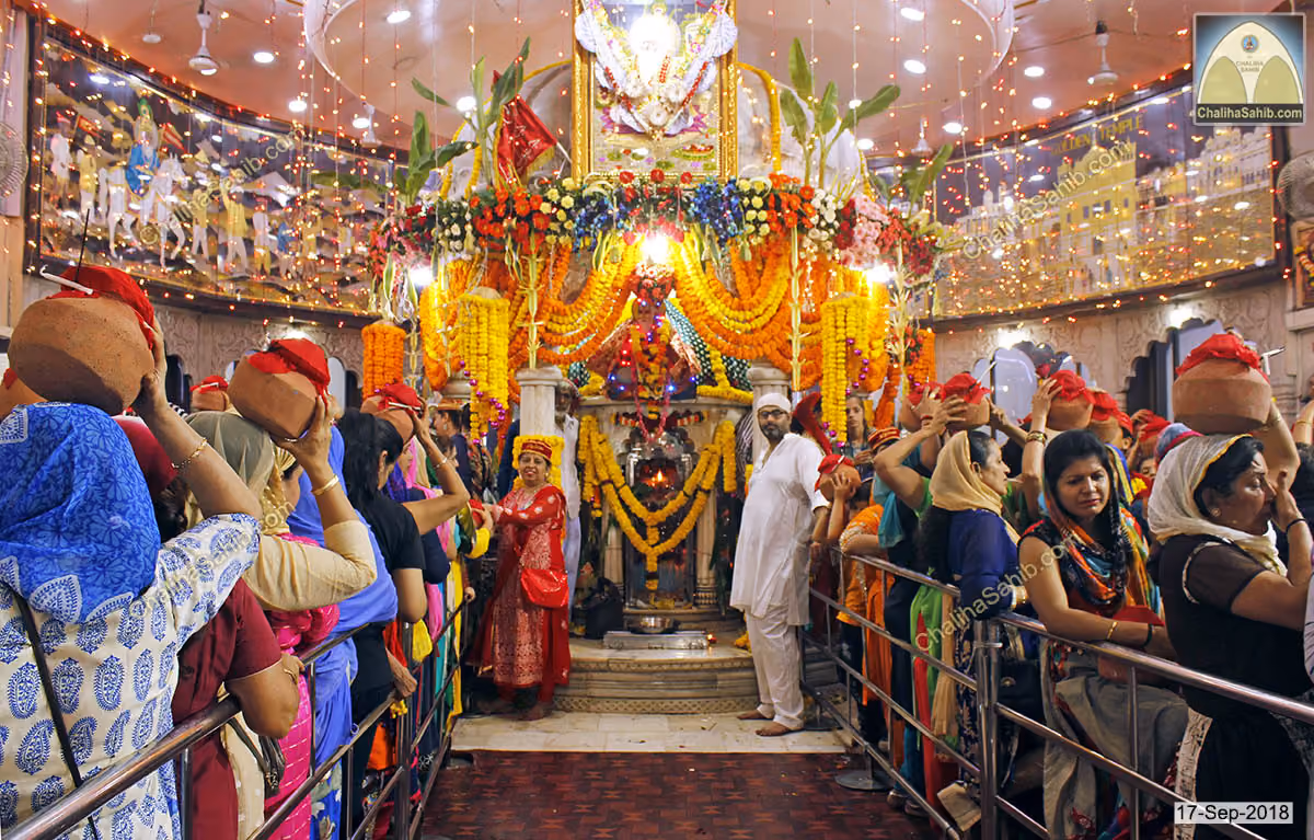 Devotees carrying matkis during Chaliha Sahib at the mandir