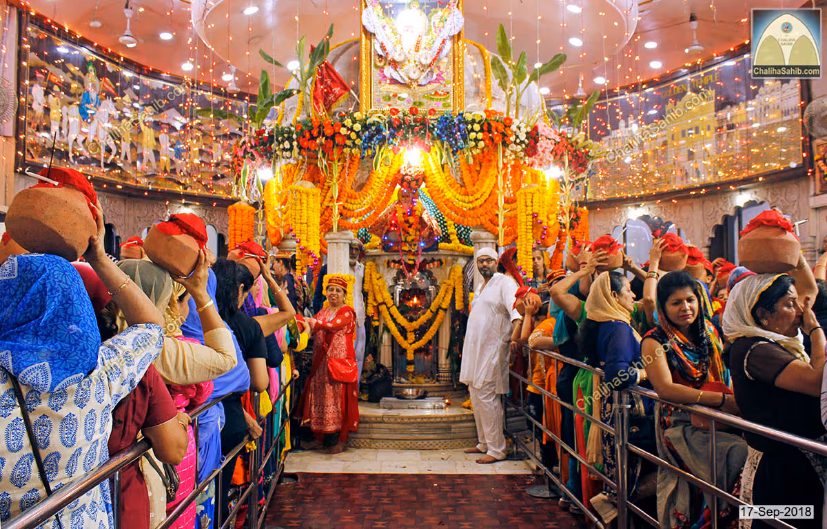 Devotees carrying matkis during Chaliha Sahib at the mandir